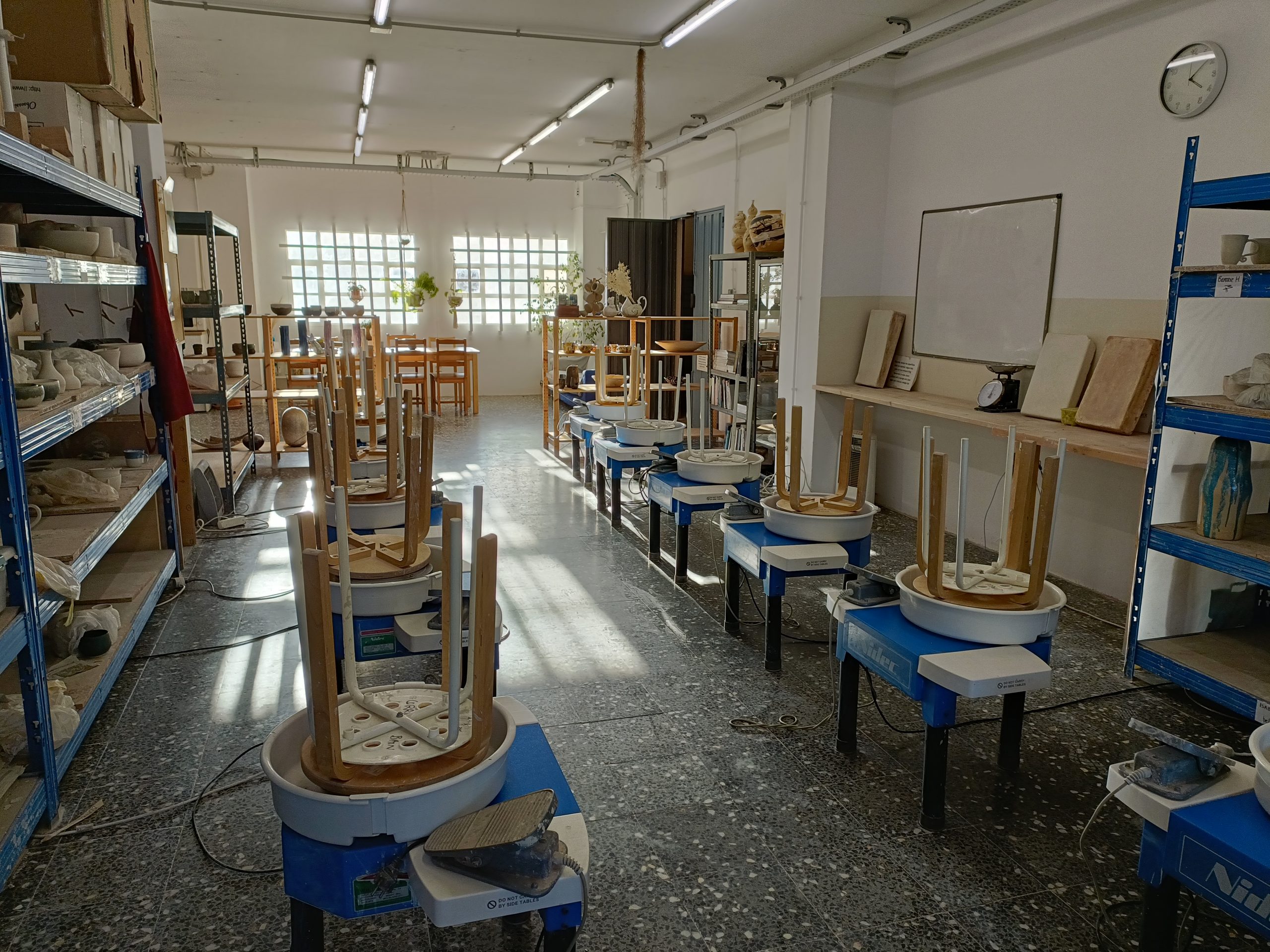 Eight Shimpo throwing wheels in the teaching area at Corrie Bain International Ceramic school.