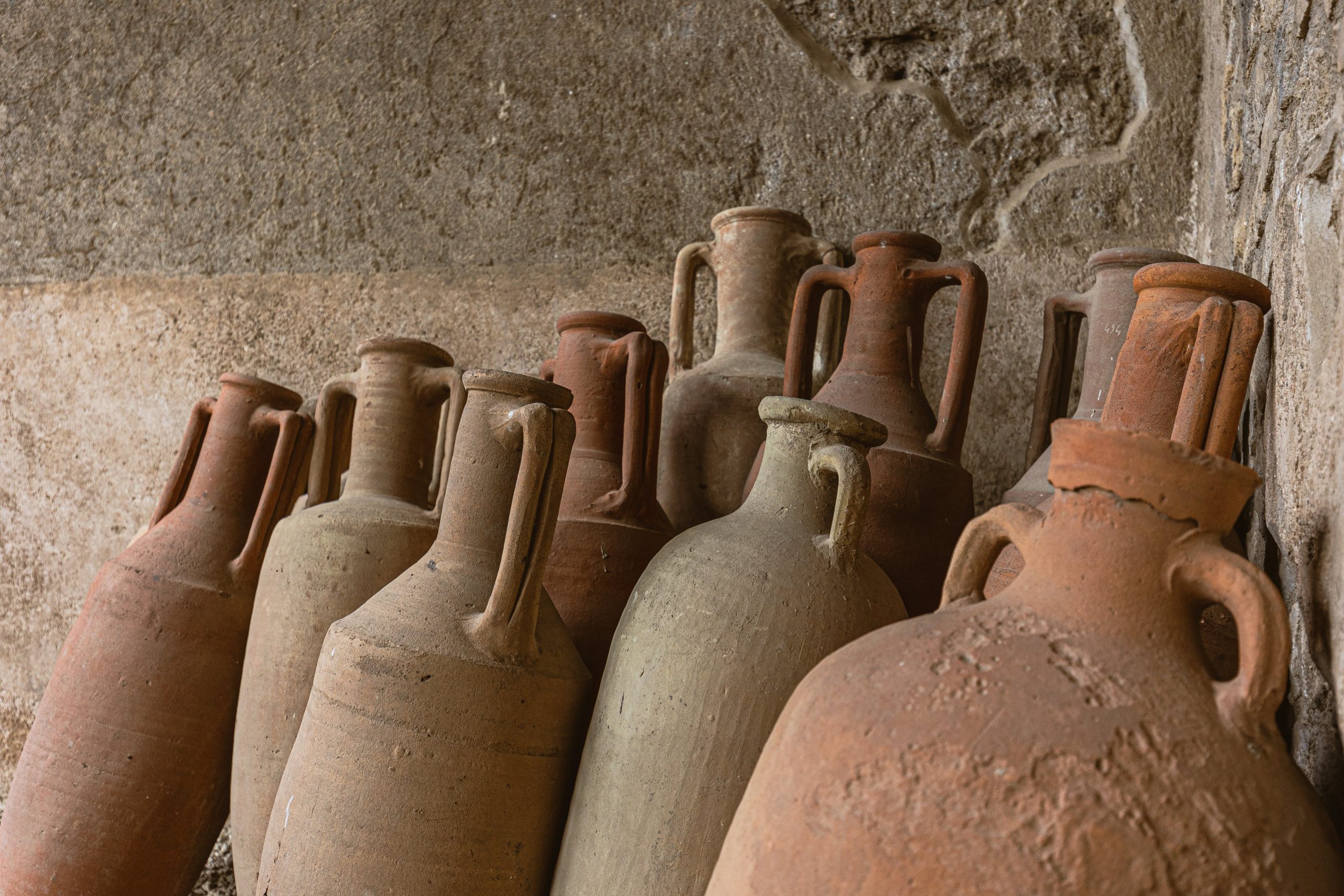 Barcelona ceramics: a group of amphorae leaning against an old wall