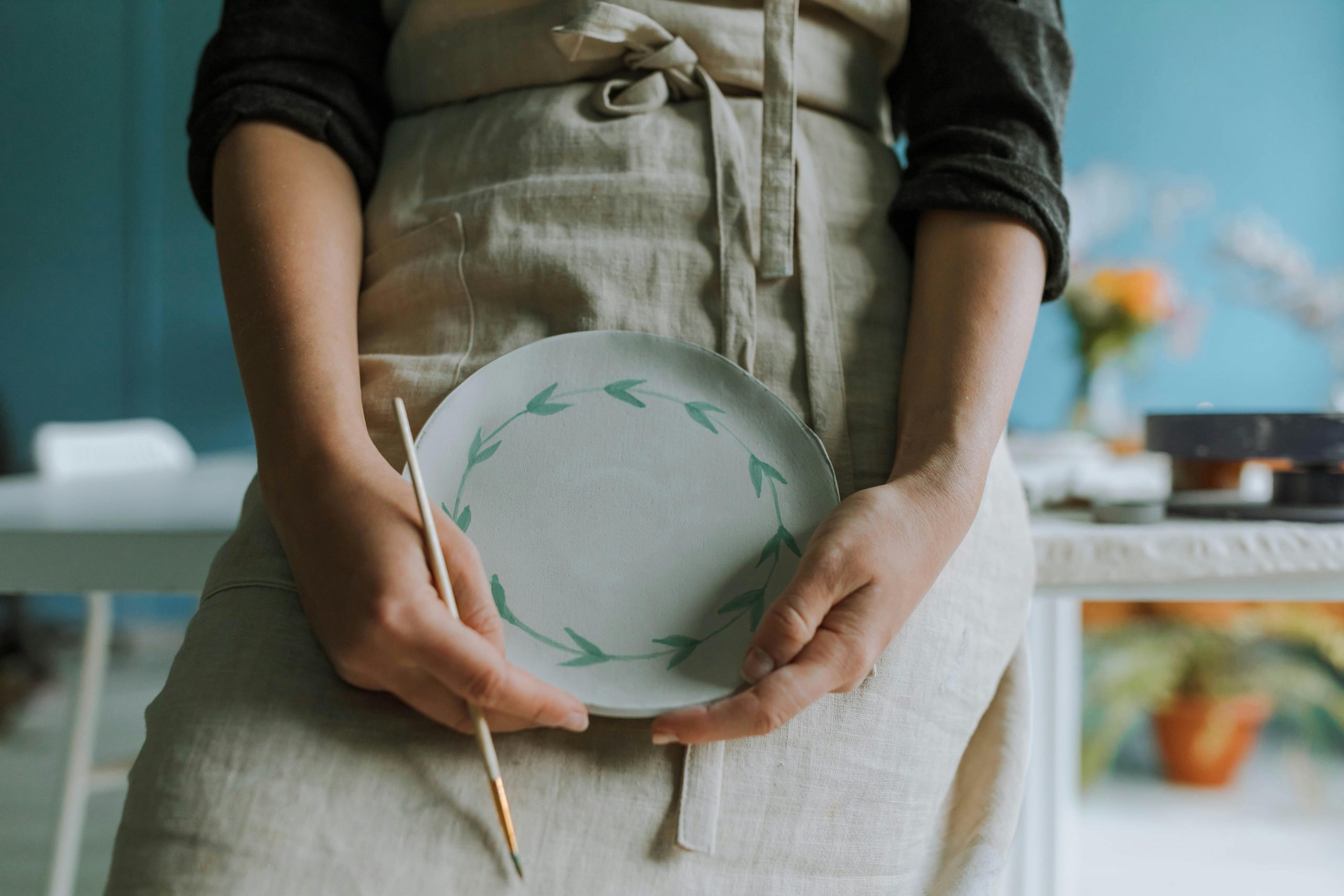Pottery student holding a plate